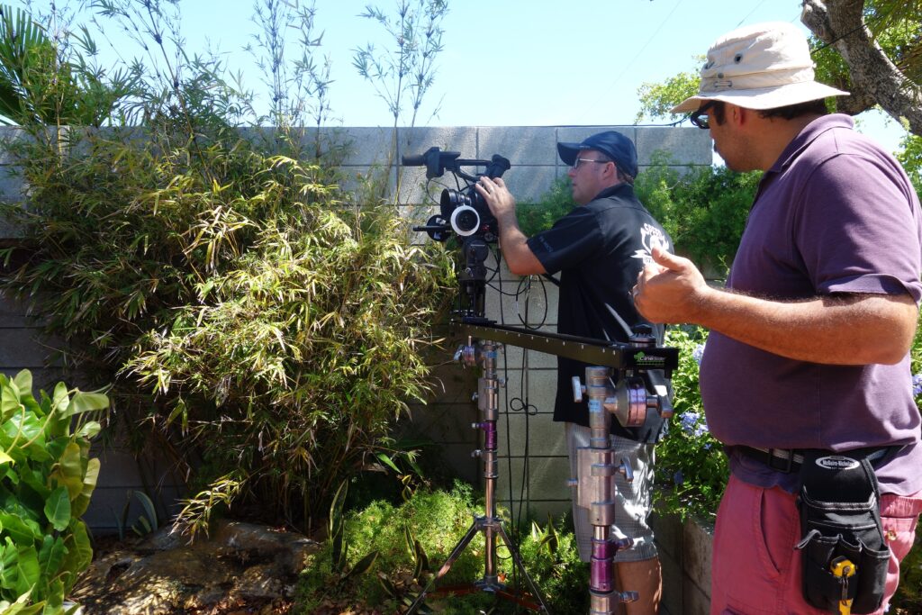 Man filming in a garden